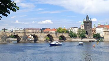 Dan Brown Prague Secret of Secrets locations 2026 — Charles Bridge at dawn