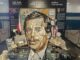 Anamorphic art installation of Václav Havel's face made from vintage objects at Prague Airport