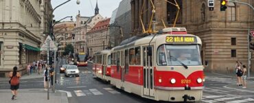 Urban tram in Prague passing along historic buildings