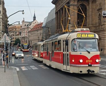 Urban tram in Prague passing along historic buildings