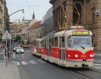 Urban tram in Prague passing along historic buildings