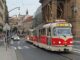 Urban tram in Prague passing along historic buildings