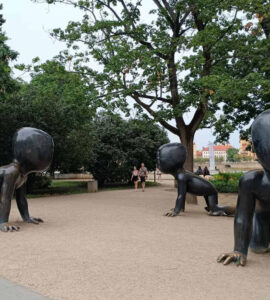Crawling Babies sculptures by David Černý in Kampa Park, Prague, featuring giant crawling baby statues with barcode faces.