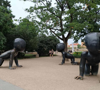 Crawling Babies sculptures by David Černý in Kampa Park, Prague, featuring giant crawling baby statues with barcode faces.
