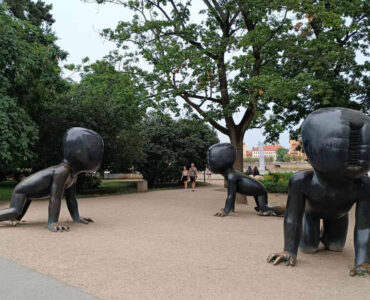 Crawling Babies sculptures by David Černý in Kampa Park, Prague, featuring giant crawling baby statues with barcode faces.