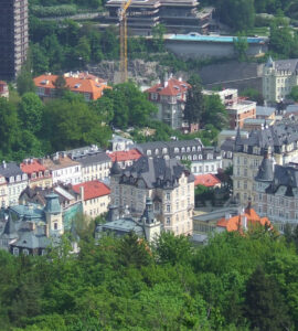 Panoramic skyline view of Karlovy Vary spa town surrounded by green hills