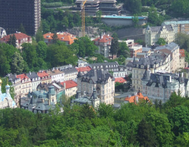 Panoramic skyline view of Karlovy Vary spa town surrounded by green hills